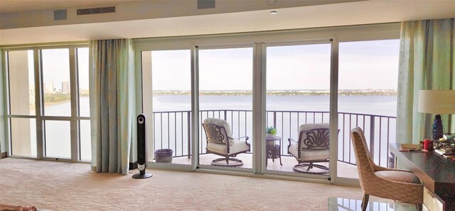 3301 Bayshore Blvd Unit 2401E, Tampa, FL 33629 - living area featuring carpet floors, visible vents, a water view, and a wealth of natural light
