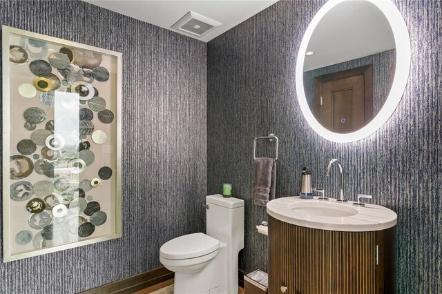 3301 Bayshore Blvd Unit 2401E, Tampa, FL 33629 - bathroom with visible vents, vanity, toilet, and wallpapered walls