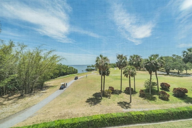 view of community with a water view and a yard