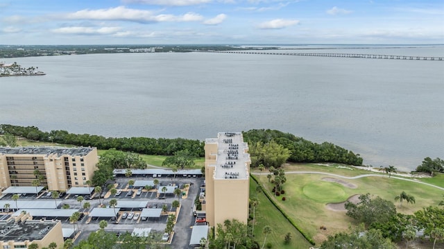 aerial view with golf course view and a water view