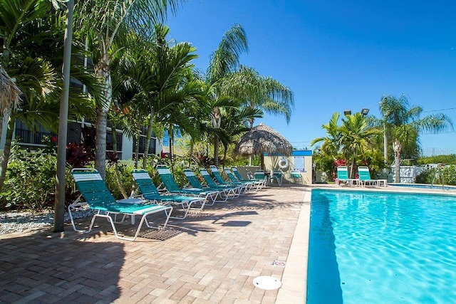 pool with fence and a patio area