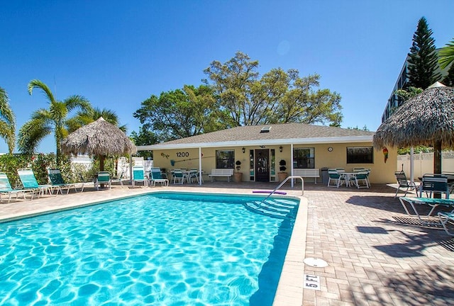 pool with fence and a patio area