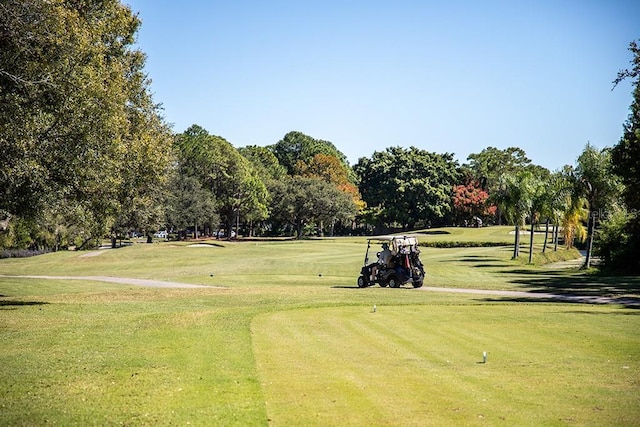 view of home's community with a lawn and golf course view