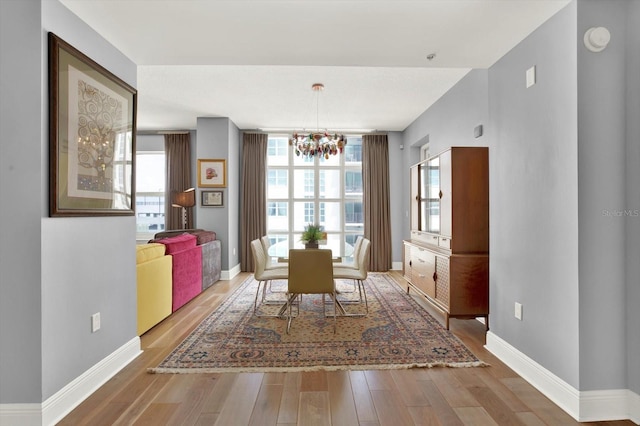 1238 E Kennedy Blvd Unit 702, Tampa, FL 33602 - dining room with a chandelier, wood finished floors, and baseboards