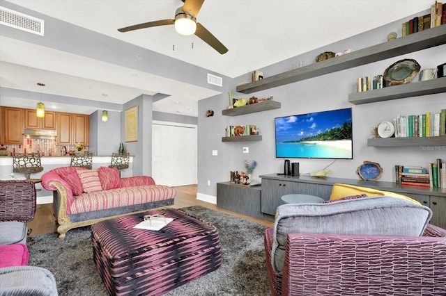 1238 E Kennedy Blvd Unit 702, Tampa, FL 33602 - living room with wood finished floors, ceiling fan, and baseboards