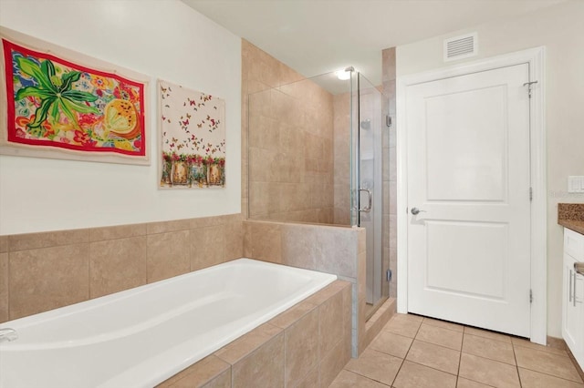 1238 E Kennedy Blvd Unit 702, Tampa, FL 33602 - bathroom featuring a shower stall, a garden tub, tile patterned floors, and vanity