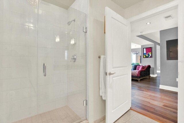 1238 E Kennedy Blvd Unit 702, Tampa, FL 33602 - ensuite bathroom featuring a shower stall, baseboards, and electric panel