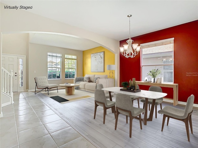 1705 Plantation Pointe Dr, Orlando, FL 32824 - dining area featuring arched walkways, a chandelier, and light wood finished floors