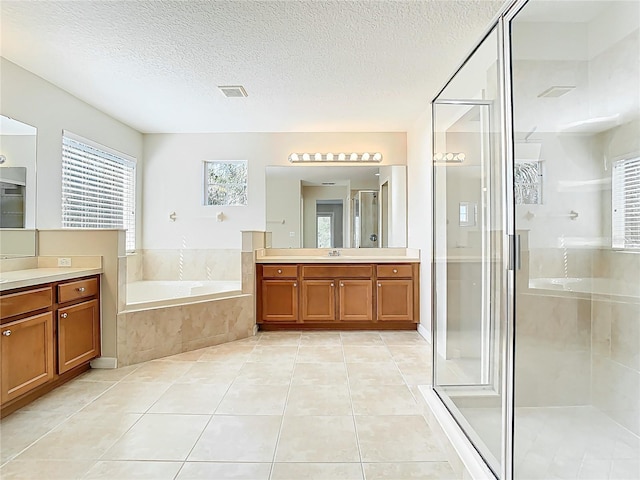 1705 Plantation Pointe Dr, Orlando, FL 32824 - full bath with vanity, a garden tub, a stall shower, tile patterned floors, and a textured ceiling