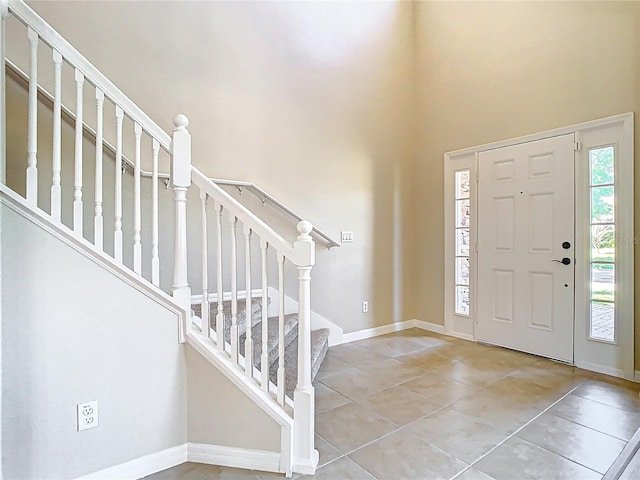 1705 Plantation Pointe Dr, Orlando, FL 32824 - tiled foyer featuring a high ceiling and stairway