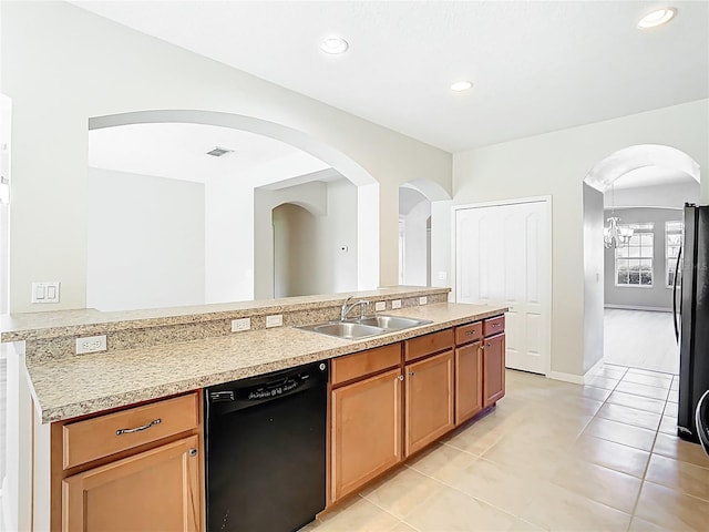1705 Plantation Pointe Dr, Orlando, FL 32824 - kitchen featuring dishwasher, light countertops, freestanding refrigerator, light tile patterned floors, and arched walkways
