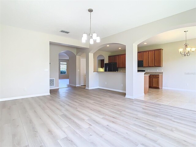 1705 Plantation Pointe Dr, Orlando, FL 32824 - unfurnished living room featuring a chandelier, light wood finished floors, and recessed lighting