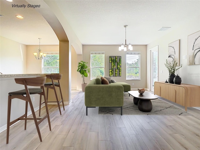 1705 Plantation Pointe Dr, Orlando, FL 32824 - living area featuring a chandelier, arched walkways, light wood-type flooring, and recessed lighting