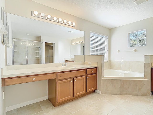 1705 Plantation Pointe Dr, Orlando, FL 32824 - bathroom with vanity, a stall shower, tile patterned floors, a garden tub, and a textured ceiling
