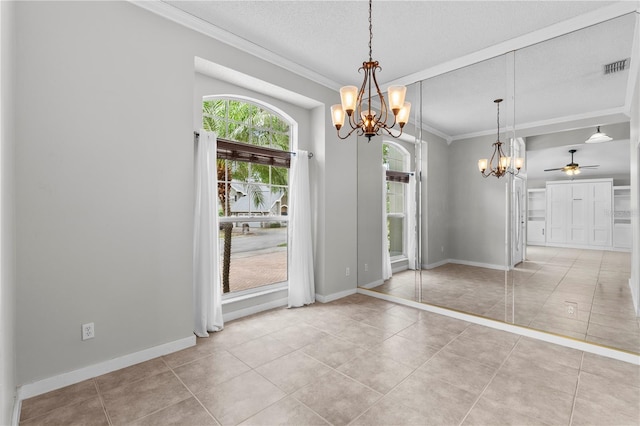 unfurnished dining area featuring tile patterned flooring, crown molding, visible vents, baseboards, and ceiling fan with notable chandelier