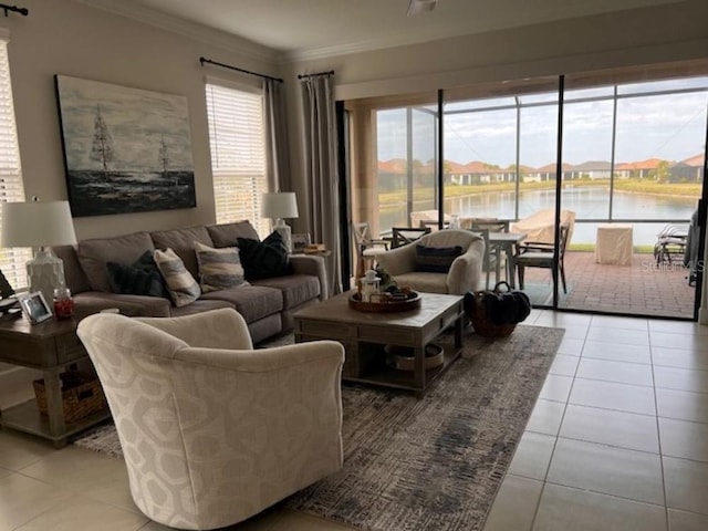 living room featuring crown molding, a water view, and light tile patterned floors