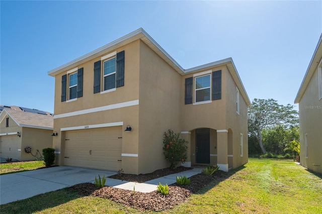 traditional home featuring stucco siding, concrete driveway, a front lawn, and a garage