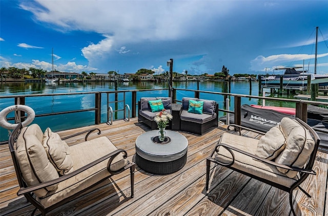 333 Island Way Unit 203, Clearwater Beach, FL 33767 - dock area with an outdoor living space and a water view