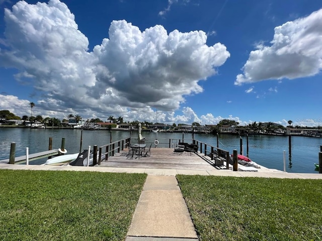 333 Island Way Unit 203, Clearwater Beach, FL 33767 - view of dock with a lawn and a water view