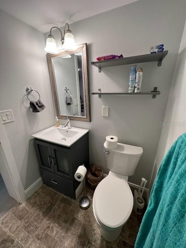 333 Island Way Unit 203, Clearwater Beach, FL 33767 - bathroom with toilet, vanity, and baseboards