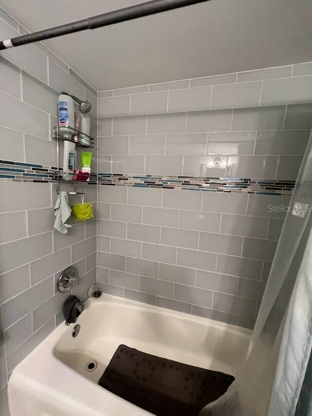333 Island Way Unit 203, Clearwater Beach, FL 33767 - bathroom featuring shower / bath combo with shower curtain