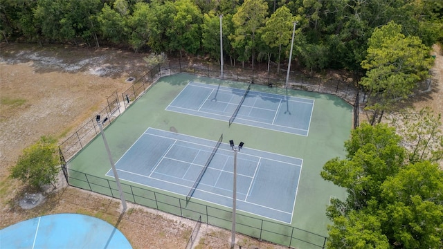 view of tennis court with fence