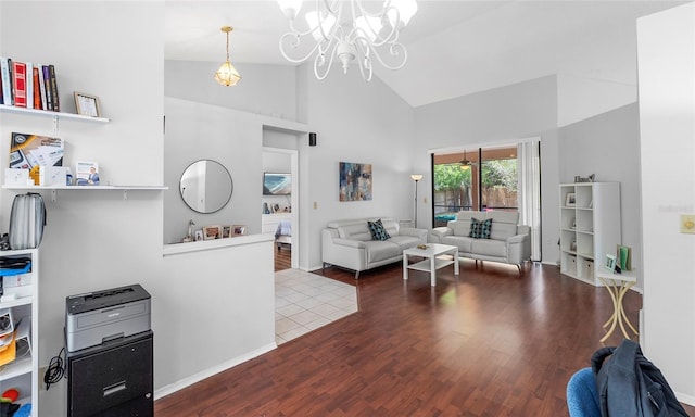 living room featuring high vaulted ceiling, wood finished floors, a chandelier, and baseboards