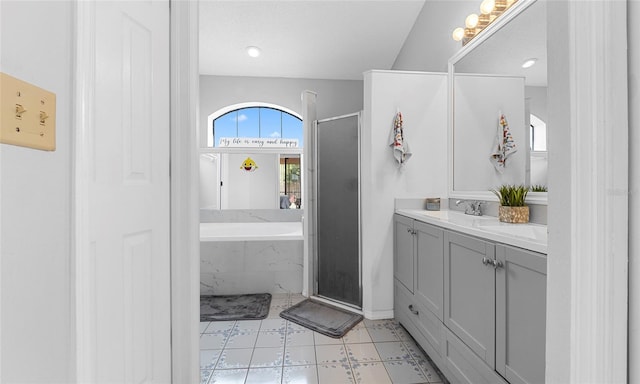 full bathroom with a shower stall, a garden tub, double vanity, and baseboards