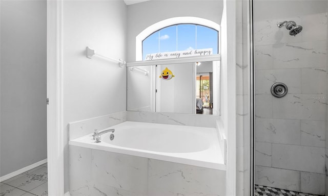 bathroom with marble finish floors, a shower stall, a bath, and baseboards