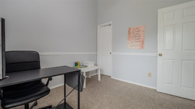 carpeted office featuring baseboards