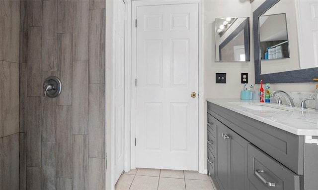 bathroom featuring tile patterned floors, vanity, and tiled shower