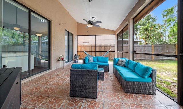 sunroom / solarium featuring a ceiling fan, lofted ceiling, and an outdoor hangout area