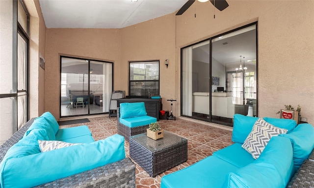 sunroom / solarium featuring an outdoor living space, ceiling fan, lofted ceiling, and healthy amount of natural light