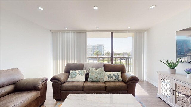 400 Island Way Unit 210, Clearwater Beach, FL 33767 - living area with light wood finished floors, recessed lighting, and baseboards