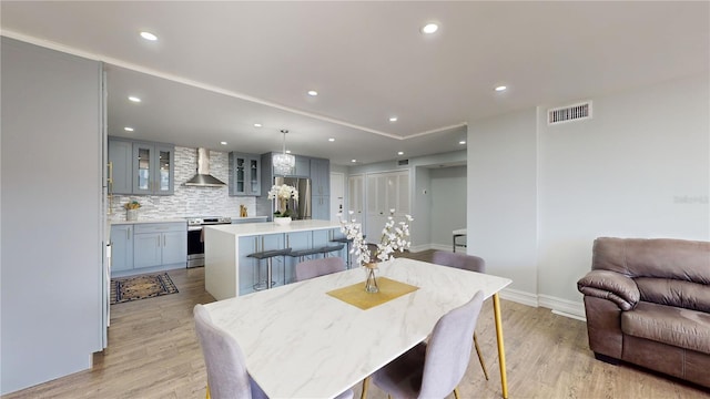 400 Island Way Unit 210, Clearwater Beach, FL 33767 - dining space with light wood-style flooring, baseboards, and recessed lighting