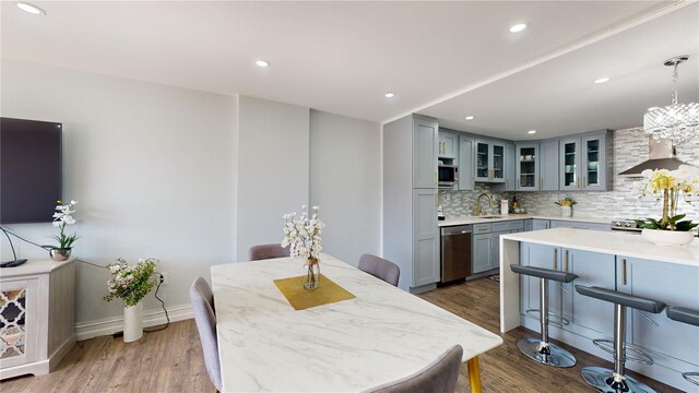 400 Island Way Unit 210, Clearwater Beach, FL 33767 - dining room featuring wood finished floors, recessed lighting, a chandelier, and baseboards