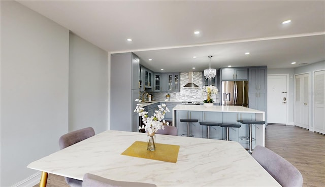 400 Island Way Unit 210, Clearwater Beach, FL 33767 - dining area featuring wood finished floors, recessed lighting, a chandelier, and baseboards