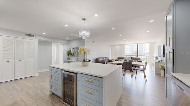 400 Island Way Unit 210, Clearwater Beach, FL 33767 - kitchen with gray cabinetry, wine cooler, light wood-style flooring, light countertops, and recessed lighting