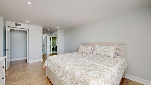 400 Island Way Unit 210, Clearwater Beach, FL 33767 - bedroom featuring light wood-style floors, baseboards, and recessed lighting