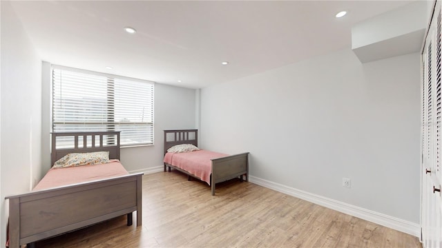 400 Island Way Unit 210, Clearwater Beach, FL 33767 - bedroom with light wood-style flooring, baseboards, and recessed lighting