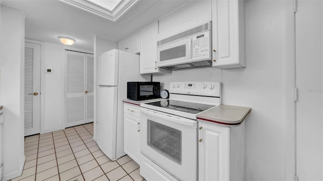 17400 Gulf Blvd Unit I4, North Redington Beach, FL 33708 - kitchen with white cabinets, light countertops, white appliances, and light tile patterned floors