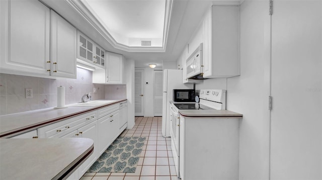 17400 Gulf Blvd Unit I4, North Redington Beach, FL 33708 - kitchen featuring a sink, white appliances, light tile patterned floors, a raised ceiling, and white cabinetry