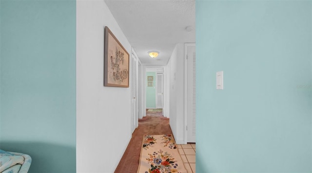 17400 Gulf Blvd Unit I4, North Redington Beach, FL 33708 - hall featuring light colored carpet, baseboards, light tile patterned flooring, and a textured ceiling