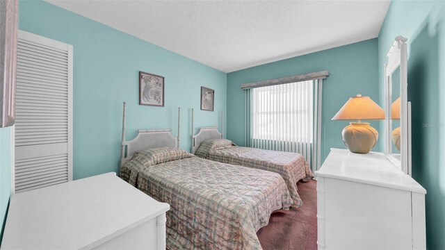 17400 Gulf Blvd Unit I4, North Redington Beach, FL 33708 - bedroom with dark colored carpet and a textured ceiling