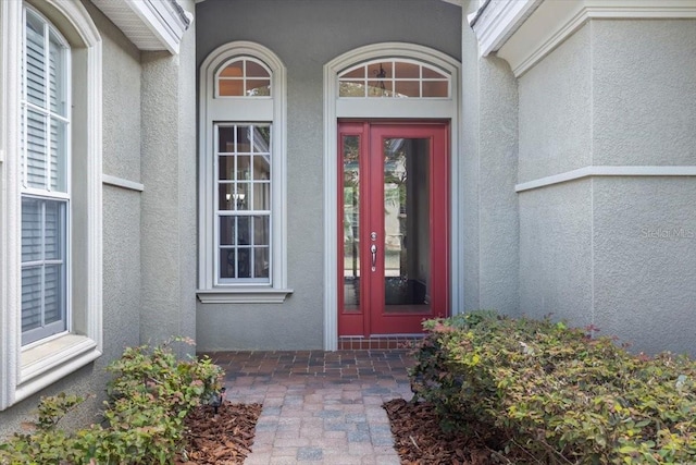 doorway to property with stucco siding and french doors