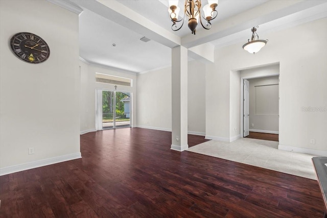 interior space featuring a chandelier, wood finished floors, baseboards, and ornamental molding