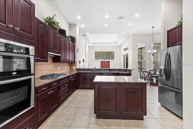 kitchen with dark brown cabinets, stainless steel appliances, light tile patterned flooring, and a sink