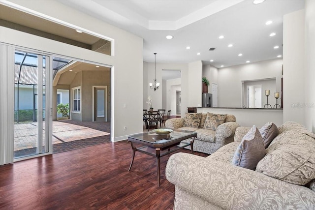 living room featuring an inviting chandelier, wood finished floors, visible vents, baseboards, and recessed lighting