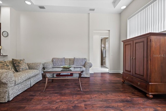 living area with visible vents, wood finished floors, baseboards, and recessed lighting