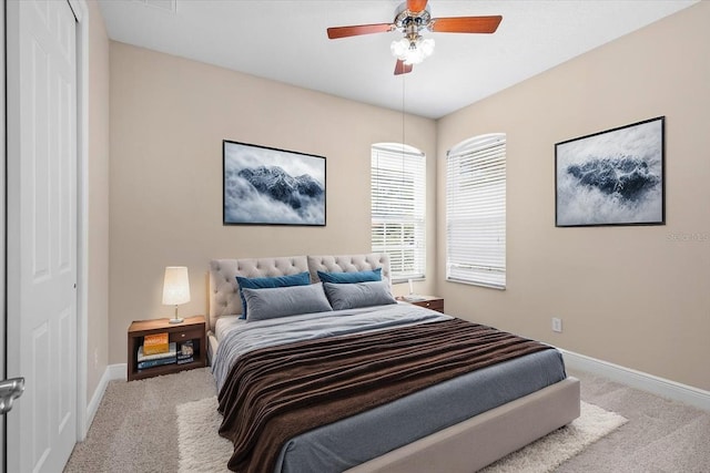 carpeted bedroom with baseboards, a closet, and ceiling fan